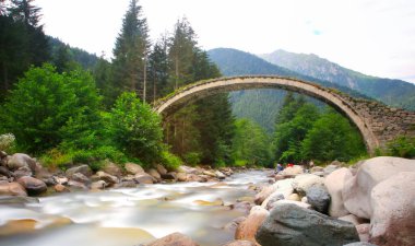 Daytime long exposure with neutral density filter of Firtina Creek and Historical Ottoman Stone Bridge. Kakar Mountains National Park, Rize, Turkey
