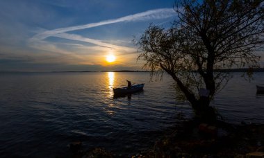 Fishing boats and net fisherman throwing into the lake, Lake Eber, Afyonkarahisar
