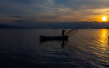 Fishing boats and net fisherman throwing into the lake, Lake Eber, Afyonkarahisar