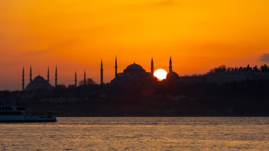 Blue Mosque and Hagia Sophia , Wonderful Istanbul view at sunset, sun dancing between minarets