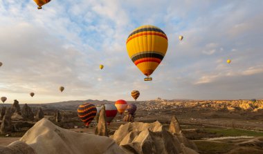 Kapadokya 'da uçan balonlar, gün doğumunda Greme' de. Kapadokya tüm dünyada sıcak hava balonlarıyla uçmak için en iyi yerlerden biri olarak bilinir.. 