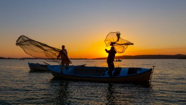 Balıkçılar göle ağ atıyorlar.