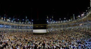Umra ya da Hac sırasında Mekke 'deki Kutsal Kabe' de Tawaf yapan, Mescid-i Haram 'ın tepesinden bakan bir grup insan. Geceleri uzun pozlama