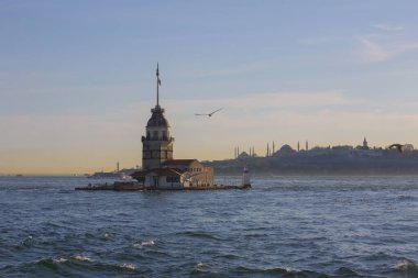 Fiery sunset over Bosphorus with famous Maiden's Tower (Kiz Kulesi) also known as Leander's Tower, symbol of Istanbul, Turkey. 