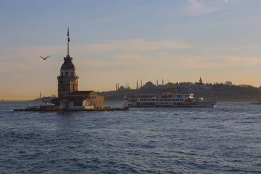 Fiery sunset over Bosphorus with famous Maiden's Tower (Kiz Kulesi) also known as Leander's Tower, symbol of Istanbul, Turkey. 