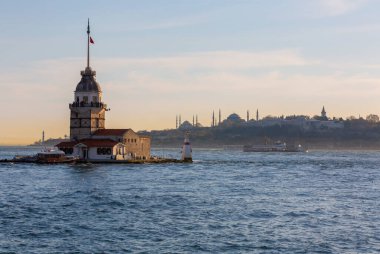 Fiery sunset over Bosphorus with famous Maiden's Tower (Kiz Kulesi) also known as Leander's Tower, symbol of Istanbul, Turkey. 