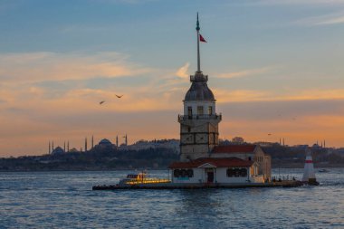 Fiery sunset over Bosphorus with famous Maiden's Tower (Kiz Kulesi) also known as Leander's Tower, symbol of Istanbul, Turkey. 