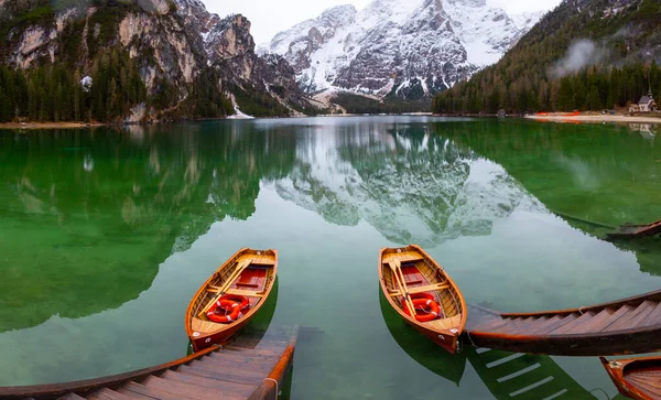 Braies Lake in Dolomites mountains Seekofel in background, Sudtirol, Italy. Lake Braies is also known as Lago di Braies. The lake is surrounded by the mountains which are reflected in the water.