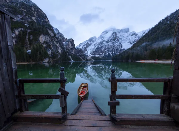 Braies Lake in Dolomites mountains Seekofel in background, Sudtirol, Italy. Lake Braies is also known as Lago di Braies. The lake is surrounded by the mountains which are reflected in the water.