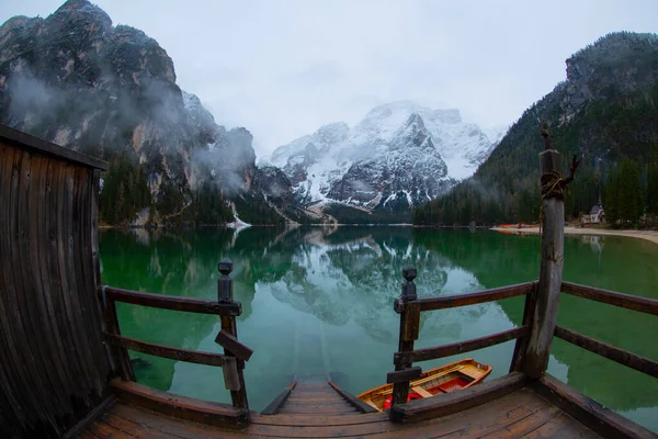 Braies Lake in Dolomites mountains Seekofel in background, Sudtirol, Italy. Lake Braies is also known as Lago di Braies. The lake is surrounded by the mountains which are reflected in the water.