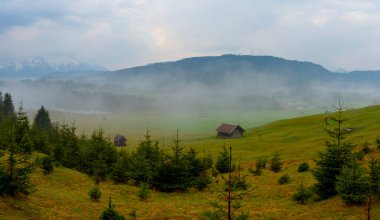Orman kenarında dağ çayırında küçük bir kulübe, Geroldsee arka planda Karwendel Dağları gündoğumunda, Kaltenbrunn, Yukarı Bavyera, Almanya