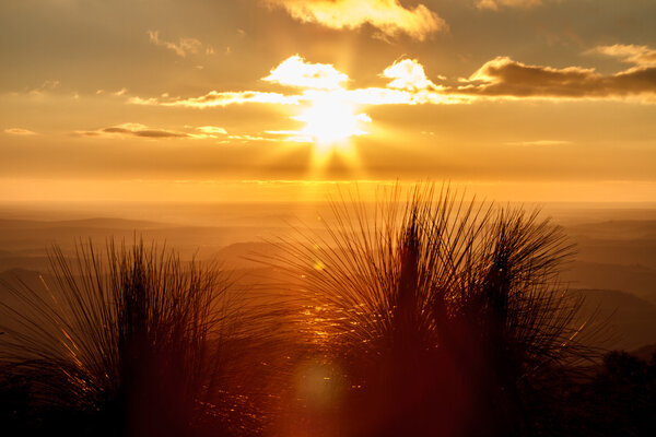 Orange sunset over the misty valley