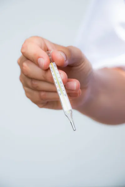 Doctor and thermometer — Stock Photo, Image