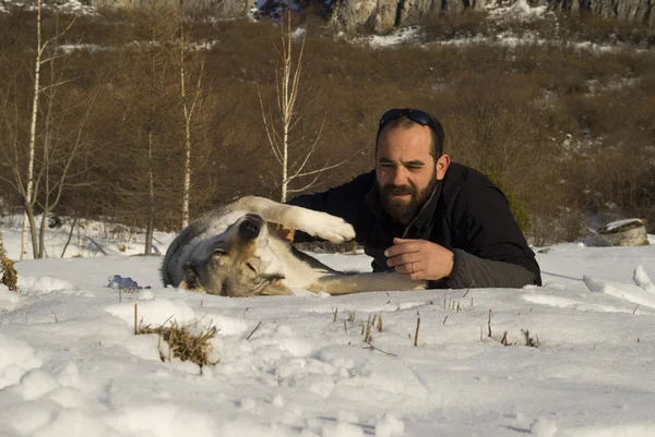 Uomo con cane nella foresta invernale — Foto Stock