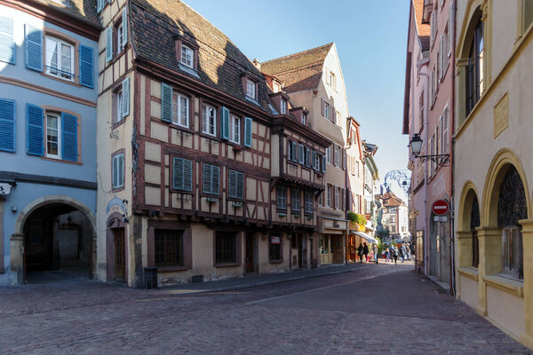 Colmar, France - October 24, 2021: View along pedestrian street in the historic center of Colmar, surrounded well-preserved half-timbered buildings