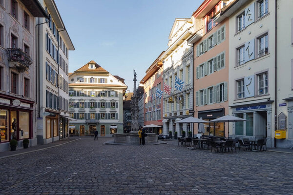Lucerne, Switzerland - October 23, 2021: View along pedestrian street in the historic center of Lucerne, surrounded well-preserved ancient buildings