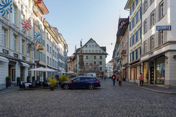 Lucerne, Switzerland - October 23, 2021: View along pedestrian street in the historic center of Lucerne, surrounded well-preserved ancient buildings