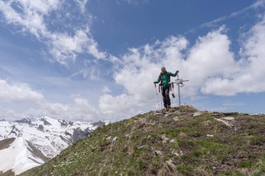 Mountain hiker standing on peak, Cottian Alps, Italy