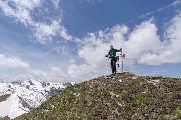 Mountain hiker standing on peak, Cottian Alps, Italy