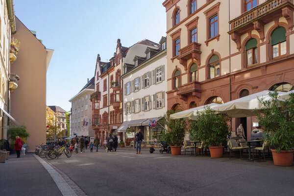 Basel, Switzerland - October 23, 2021: View along street in the center of old town Basel, surrounded well-preserved ancient buildings