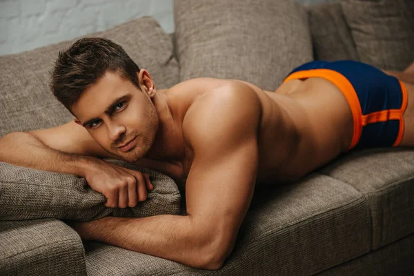 Handsome young male model lies on stomach