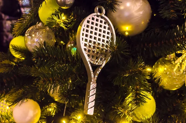 christmas decorations on the tree in the form of a tennis racket. High quality photo