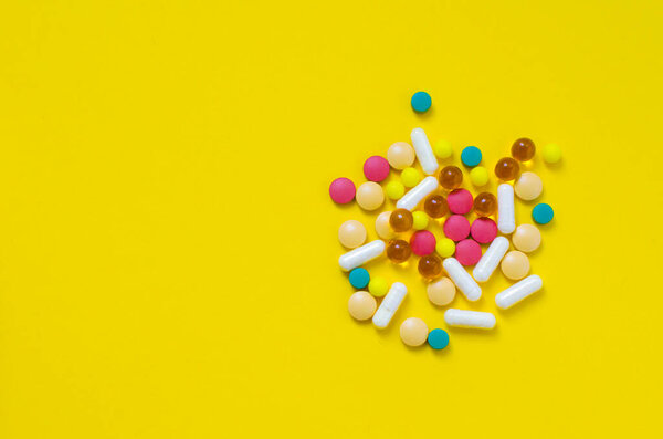 a lot of medical drugs on a yellow background flatlay. High quality photo