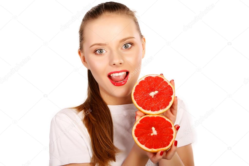 Young blonde woman with grapefruit in her hands studio portrait