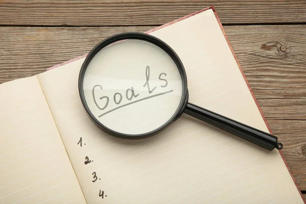 Goals Memo Notebook Magnifying Glass Grey Wooden Background Top View — Stock Photo, Image