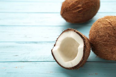 Fresh coconut on blue wooden background.