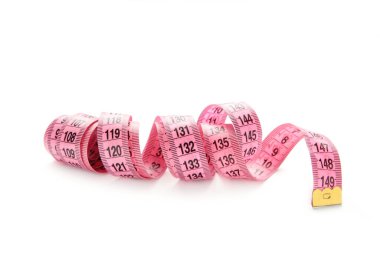 Pink plastic measure tape with metric scale isolated on white background. Top view. Diet concept