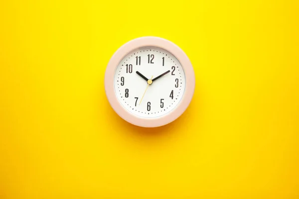 Pink Clock Yellow Background Top View Vertical Photo — Foto Stock