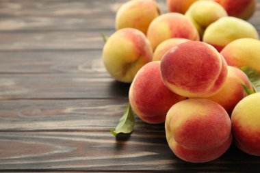 Fresh peaches on a old brown background. Top view