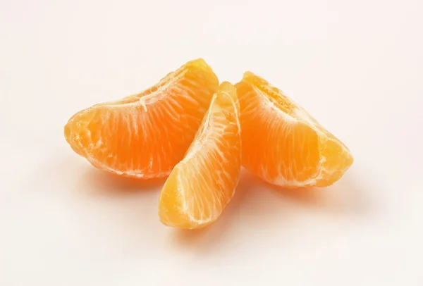 Three slices of tangerine on white background — Stock Photo, Image