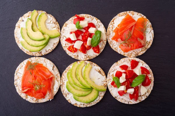 Rice cake with  salmon avocado mozzarella  and tomatoes . Healthy diet nutrion for vegan