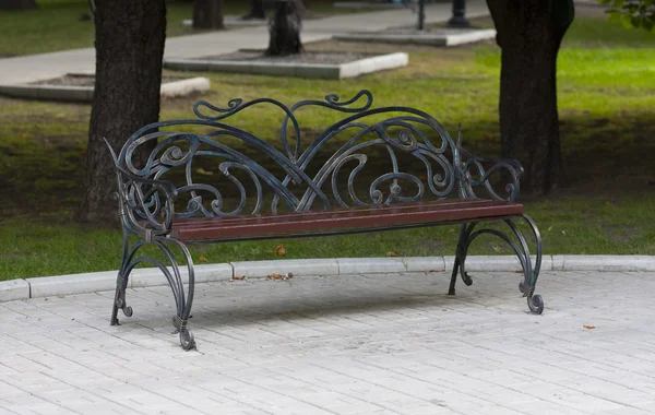 Metal forged bench in summer park — Stock Photo, Image