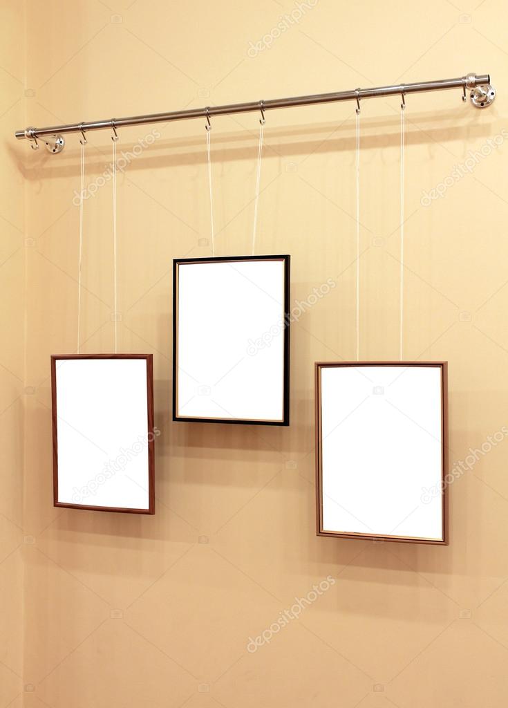 Three frames with isolated canvas on the exhibition ledge