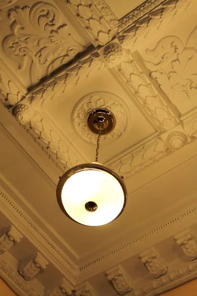 Bronze chandelier view from below with moldings — Stok fotoğraf