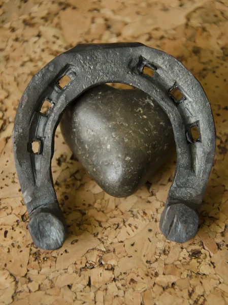 Metal forged heart and horseshoe on a cork background — Stock Photo, Image