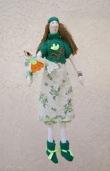 Handmade doll with a bird on the hand in a dress and sweater on — Stock Photo, Image