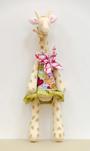 Hand made soft toy giraffe in a dress standing — Stock Photo, Image