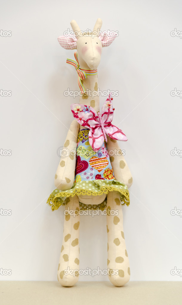 Hand made soft toy giraffe in a dress standing
