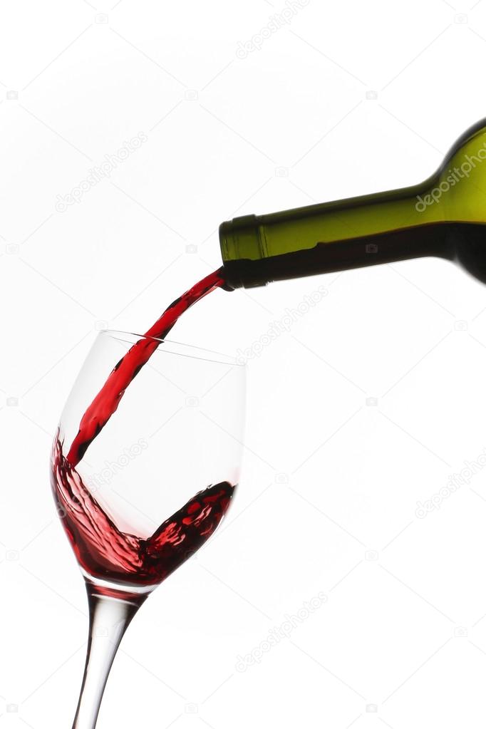 Bottle and glass with red wine splash