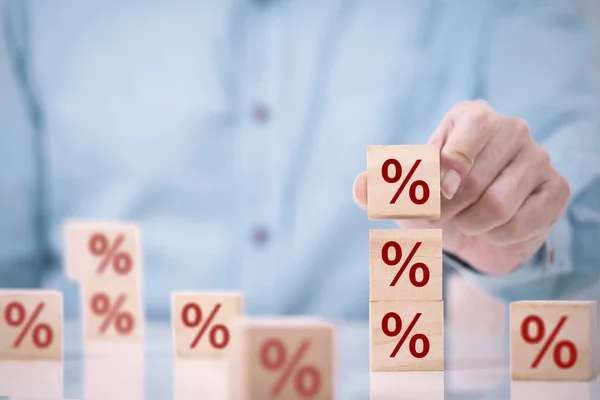 Business man chooses a wood cube block on top with percent symbol icon , concept of financial , Interest rate and mortgage rates