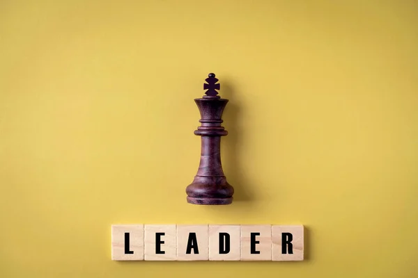 King in battle chess game stand on yellow background ,  leadership and business vision for a win in business game , Business leadership concept