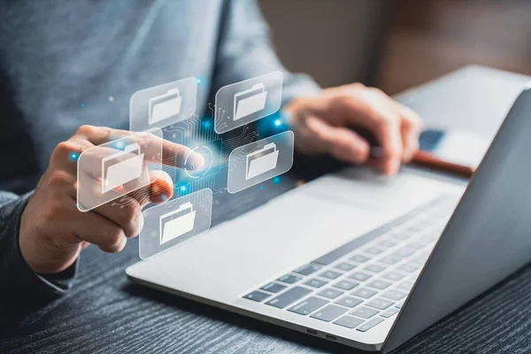 Businessman using computer laptop on e document on digital tablet , E-signing on e document and virtual notepad on virtual screen , electronic signature , paperless office concept