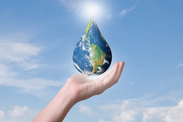 Earth globe drop shape floating in hands , Blue world globe in human hand on cloudy sky background, Energy saving , world environment day concept, Elements of this image furnished by NASA