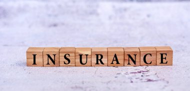 Insurance word on a wooden cubes . Health, car, real estate insurance business concept.