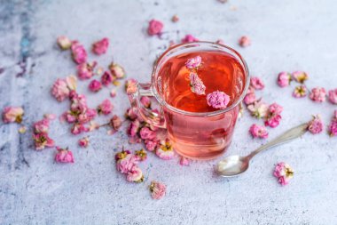 Rose buds tea in a glass cup . Tea made from tea rose petals