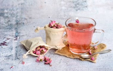 Rose buds tea in a glass cup . Tea made from tea rose petals